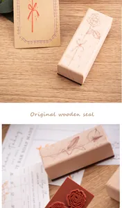 Detailed view of the floral engraving on a rectangular wooden rubber stamp.