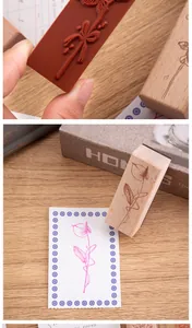 Detail of a wooden stamp with a delicate floral pattern for DIY journaling decor