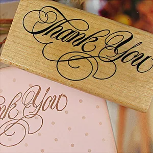 Decorative vintage wooden rubber stamp featuring artistic Thank You script for DIY cards