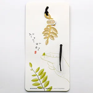 Elegant 18K gold-plated leaf-shaped metal bookmark with artistic display card