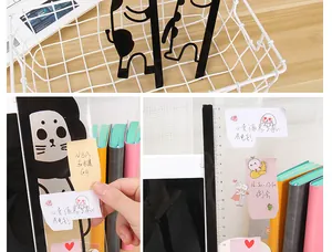 Close-up detail of transparent acrylic monitor memo board with ruler and cat design
