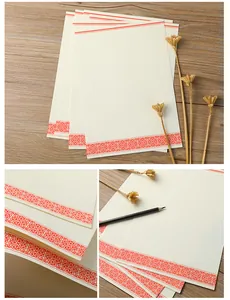 Macro view of Chinese style letter paper with traditional red patterns and wood background