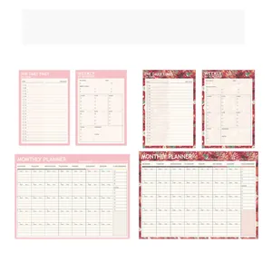Comprehensive set of pink and floral daily weekly monthly planners for desk scheduling.