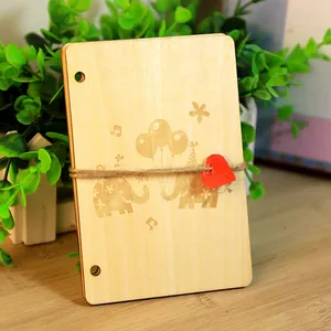 Handmade wooden greeting card with elephant engraving, twine tie and red heart tag