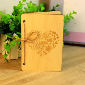 Handcrafted wooden greeting card with laser-cut heart pattern and twine bow tie