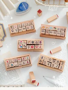 Close-up of 12pcs wooden stamp sets for diary DIY featuring cartoon and number themes