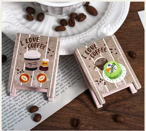 Detailed view of two vintage wooden mini easel memo clips with coffee theme prints