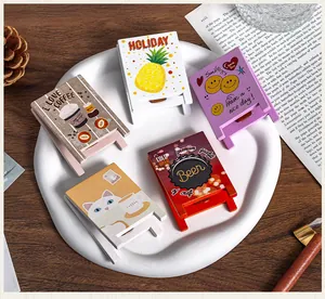 Detailed view of various cute cartoon wooden easel-shaped memo clips for desk decor