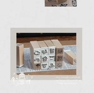 Close-up of wooden stamp set featuring various cute weather and facial expression icons