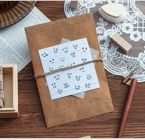 Detailed macro view of various emoji stamps on gridded paper over a brown envelope