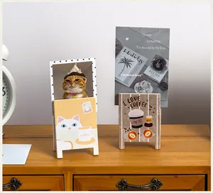 Detailed view of vintage wooden desktop photo clips with cat and coffee designs