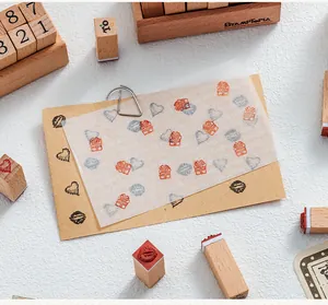 Close-up detail of 12-piece wooden rubber stamp set for DIY journaling and scrapbooking