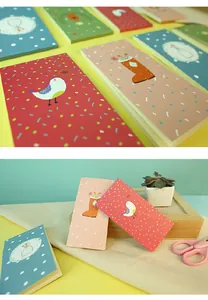 Detail of forest life illustrated memo pads with bird and floral designs in a creative setting