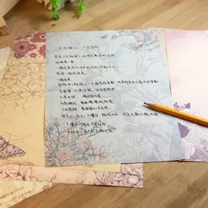 Vintage floral letter paper and envelopes set with elegant flower patterns on wood.