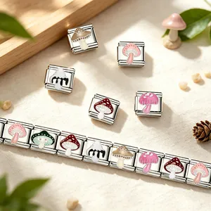 Detailed view of colorful mushroom enamel charms on a stainless steel modular bracelet.
