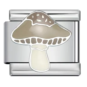 Detail view of a beige mushroom enamel charm on a stainless steel Italian bracelet link