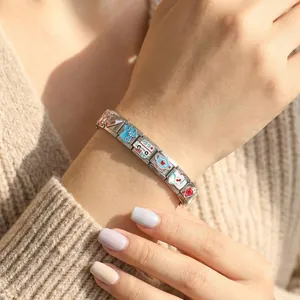 Close-up of stainless steel medical themed Italian charm bracelet on female wrist