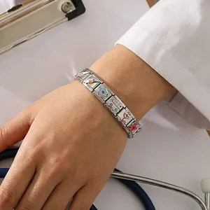 Close-up of medical themed stainless steel Italian modular charm bracelet on a model wrist