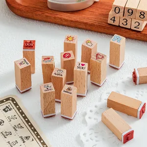 12-piece wooden stamps set for DIY journaling with cartoon travel and number designs