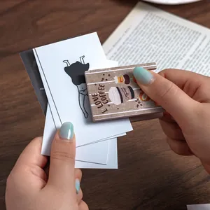 Vintage wood-style coffee-themed desk note clip holding several cards in hand