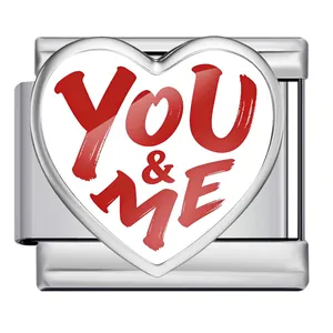 Macro view of a heart-shaped Italian modular charm with red YOU & ME text