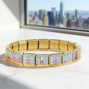 Close-up of gold Italian charm bracelet featuring colorful world landmark designs on stainless steel links