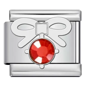 Macro view of polished stainless steel Italian charm featuring a red rhinestone bow.