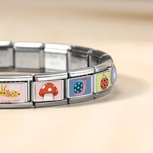 Detailed close-up of an Italian modular charm bracelet with cute bee and snail art