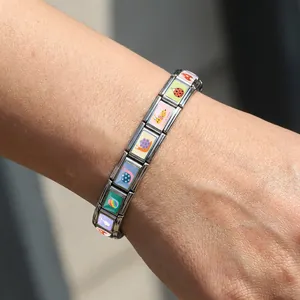 Stainless steel Italian modular charm bracelet featuring colorful bee and snail enamel designs
