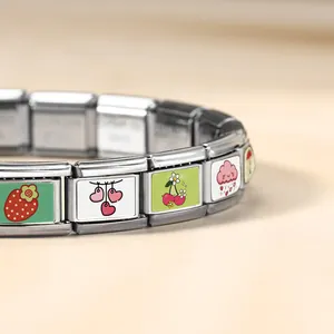Close-up detail of stainless steel Italian modular bracelet with cute heart and cloud charms
