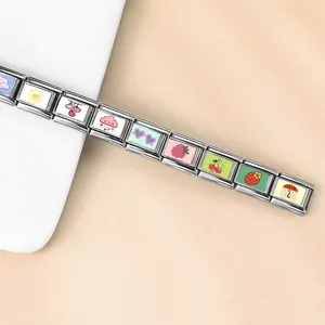 Close-up of stainless steel Italian modular bracelet with colorful cute heart and fruit charms.