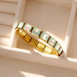Close-up of gold stainless steel Italian charm bracelet with Easter bunny patterns