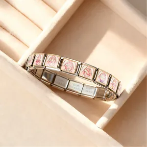 Close-up of stainless steel Easter charm bracelet with pink egg patterns