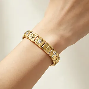 Detailed view of a gold Italian modular bracelet featuring star and cross charms on a wrist