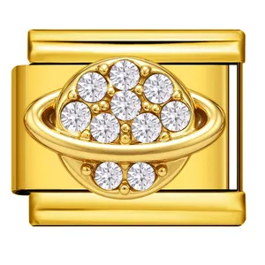 Detailed close-up of a golden Italian charm bracelet link with a sparkling crystal planet design