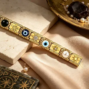 Gold stainless steel Italian charm bracelet featuring stars and evil eye motifs