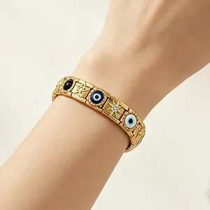 Gold-tone stainless steel evil eye and star Italian charm modular bracelet on wrist