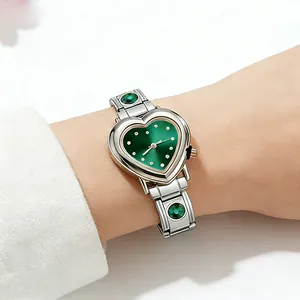 Detailed wrist view of a heart-shaped green dial watch with zircon modular strap