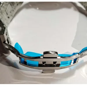 Detailed macro shot of stainless steel watch butterfly clasp with blue protective film