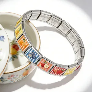 Detailed view of fruit pattern Italian charm bracelet with polished stainless steel links
