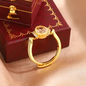 Close-up of elegant gold-plated ring featuring an oval champagne stone and side diamonds