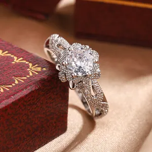 Detailed macro shot of an intricate snowflake flower ring with a sparkling round center stone.