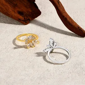 Detailed view of elegant gold and silver flower rings with sparkling cubic zirconia