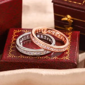 Detail view of square princess-cut zircon eternity rings in silver and rose gold.
