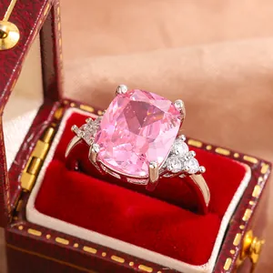 Close-up macro view of a luxury silver wedding ring with a large pink cushion gemstone