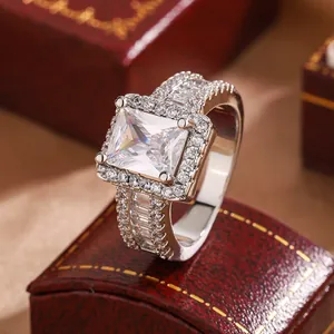 Close-up of elegant square cubic zirconia engagement ring on a red jewelry box
