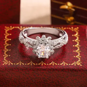 Macro detail of snowflake flower ring with round cut center stone on red box