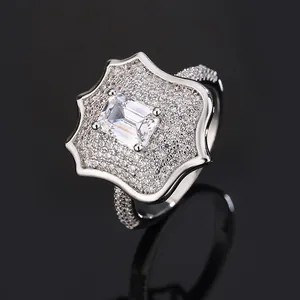 Close-up detail of silver mens flower ring with emerald-cut zirconia and pavé stones.