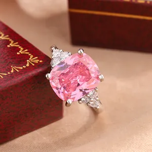 Close-up of elegant pink cushion cut engagement ring with crystal accents