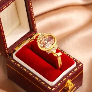 Luxury gold plated ring with champagne oval gemstone in a red velvet jewelry box
